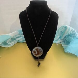 Artisan 1970s vintage boho-style agate pendant necklace on an adjustable cord.